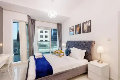 a bedroom with a large bed and a window at 1BR with Balcony, Steps from JBR & Marina Walk in Dubai