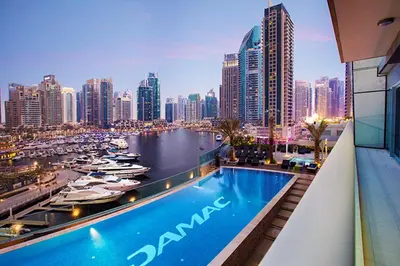 a hotel swimming pool with a view of a city at 1BR with Balcony, Steps from JBR & Marina Walk in Dubai