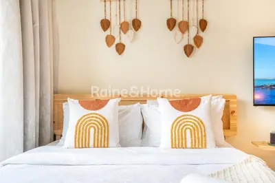 a bedroom with a bed with two hearts on the wall at RH- Modern studio walk away from Burj khalifa and Dubai Mall in Dubai