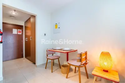 a room with a table and chairs and a door at RH- Modern studio walk away from Burj khalifa and Dubai Mall in Dubai