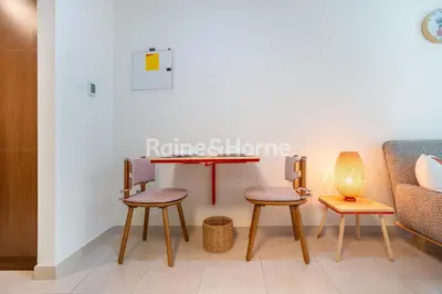 a room with three chairs and a table at RH- Modern studio walk away from Burj khalifa and Dubai Mall in Dubai