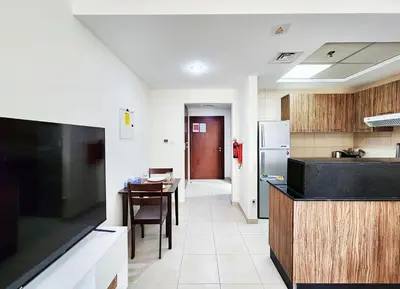 a kitchen with a counter and a table in it at RH- Contemporary Living, Studio, Near Burj Khalifa in Dubai