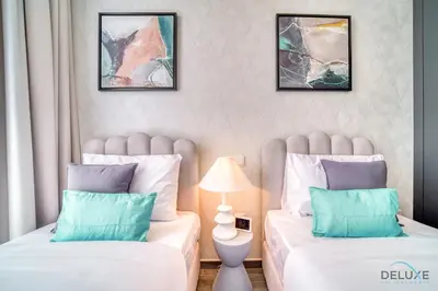 two beds sitting next to each other in a room at Peaceful 2BR with Assistant Room at Mesk 1 Midtown Dubai Production City by Deluxe Holiday Homes in Dubai