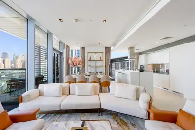 a living room with two white couches and a table at Livbnb - Alluring 3BR Plus Maid's with Sea & Ain Dubai View in Dubai