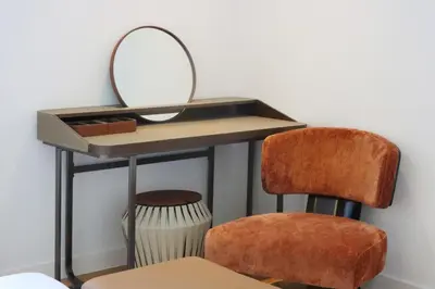 a dressing table with a mirror and a chair at Livbnb - Alluring 3BR Plus Maid's with Sea & Ain Dubai View in Dubai