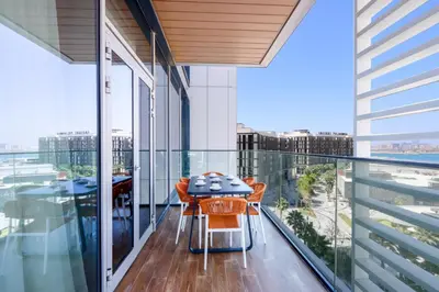 a balcony with a table and chairs on it at Livbnb - Alluring 3BR Plus Maid's with Sea & Ain Dubai View in Dubai