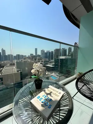 a table on a balcony with a view of a city at 5* Studio, 10min walk to Dubai Mall, 1min Bay Sqr in Dubai