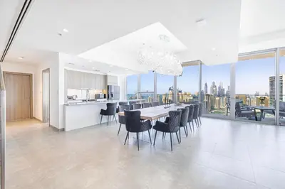 a kitchen and dining room with a table and chairs at Daniels Marina View 4BR Duplex in Stella Maris in Dubai
