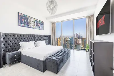 a bedroom with a large bed and a large window at Daniels Marina View 4BR Duplex in Stella Maris in Dubai