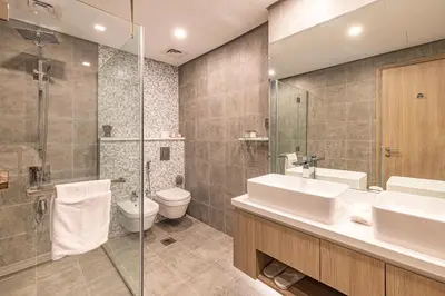 a bathroom with a sink and a toilet and a shower at Daniels Marina View 4BR Duplex in Stella Maris in Dubai