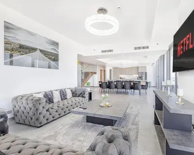 a living room with a couch and a table at Daniels Marina View 4BR Duplex in Stella Maris in Dubai