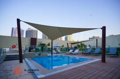 a pool on the roof of a building at Alashrafia Saray- Cozy 2BR apartment in Canal Views in Dubai