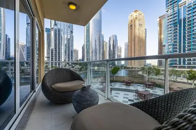a balcony with furniture and a view of a city at Spacious Apartment I Lake Views Apartment in JLT I Close To Metro in Dubai