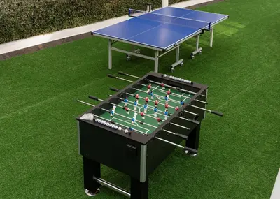 a ping pong table sitting on top of grass at Izzzi Life Mint in Dubai