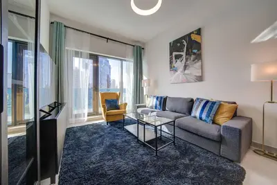 a living room with a couch and a table at Canal View l Stylish & Spacious in Dubai