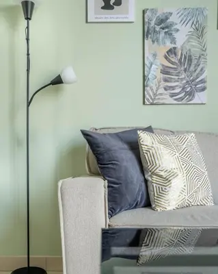 a living room with a couch with pillows and a lamp at GuestReady Holiday Homes - Sobha Urban Retreat in Dubai