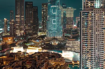 a view of a city at night at Prime Retreats @ Burj Royale By Emaar in Dubai