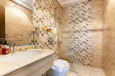a bathroom with a sink and a toilet at Lower floor studio with a sofa bed in JVC - Allsopp&Allsopp in Dubai