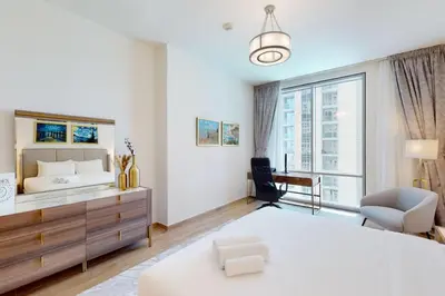 a bedroom with a large bed and a large window at Meera Tower - Sleek One Bedroom in Dubai