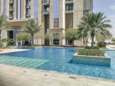 a large swimming pool in front of a building at Meera Tower - Sleek One Bedroom in Dubai