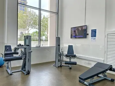 a gym with several exercise equipment and a tv at Meera Tower - Sleek One Bedroom in Dubai