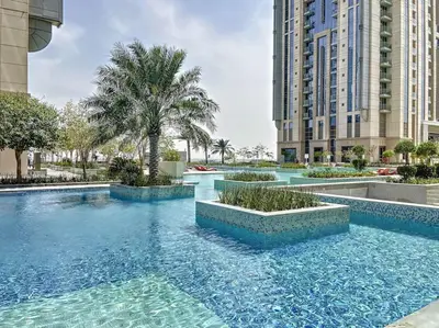 a swimming pool with blue water in a city at Meera Tower - Sleek One Bedroom in Dubai