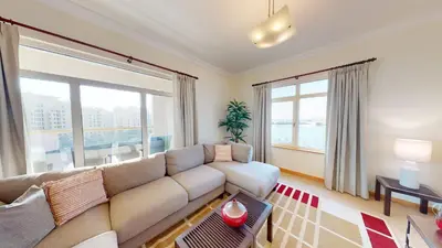 a living room with a couch and a large window at Al Dabas Beach Views, 3BD Sleeps 6, Beachfront Beach & Pool Access - DVH Holiday Homes in Dubai