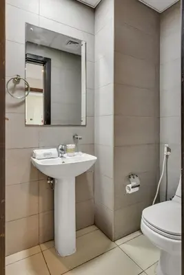 a bathroom with a sink and a toilet and a mirror at Serene 1BR with Stunning Marina Views in Dubai Marina - The Atlantic in Dubai