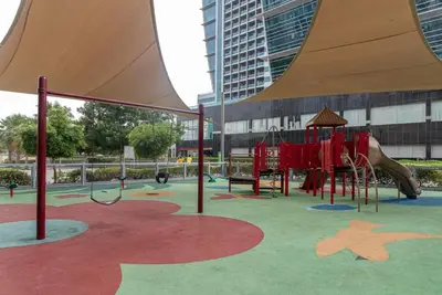 a playground with a slide and a play structure at GuestReady - Luxe Studio with JLT Park View in Dubai