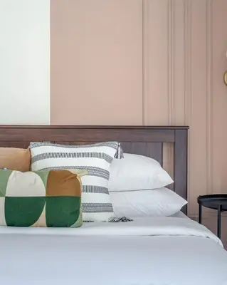 a bed with a bunch of pillows on it at GuestReady - Luxe Studio with JLT Park View in Dubai