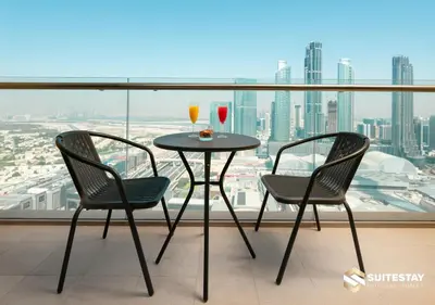 a table and two chairs with drinks on a balcony at Deluxe - Address Dubai Mall - The Residence in Dubai