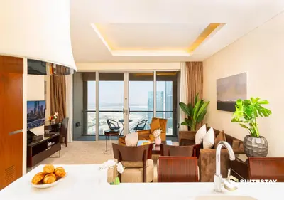 a living room with a couch and a table at Deluxe - Address Dubai Mall - The Residence in Dubai
