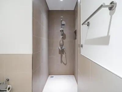 a shower with a glass door in a bathroom at Stylish 1BR in Park Heights 2 - Dubai Hills in Dubai