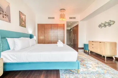 a bedroom with a large bed and a dresser at South Ridge 2, Downtown Dubai - Mint Stay in Dubai