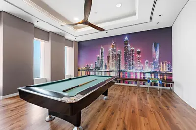 a pool table in a room with a mural of a city at 76th floor- 2 BR Apartment with Iconic Marina Skyline View in Dubai