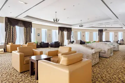 a hotel room with a bed and chairs at 76th floor- 2 BR Apartment with Iconic Marina Skyline View in Dubai