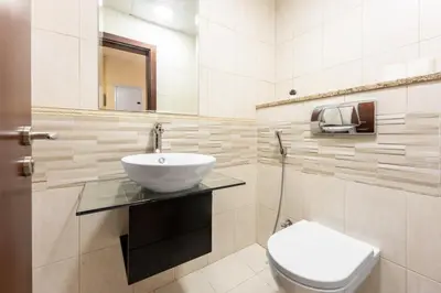 a bathroom with a sink and a toilet at 76th floor- 2 BR Apartment with Iconic Marina Skyline View in Dubai