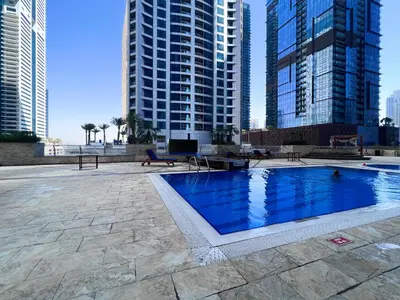 a swimming pool in a city with tall buildings at 76th floor- 2 BR Apartment with Iconic Marina Skyline View in Dubai