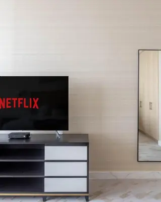 a living room with a tv on a wall at GuestReady - Bejeweled Studio at The Palm Tower in Dubai