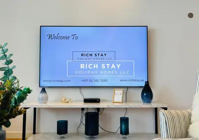 a flat screen tv sitting on top of a table at Crystal Clear 1BR in Blue Waters with Ain View in Dubai
