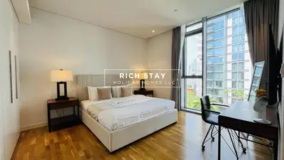 a bedroom with a bed and a desk and a window at Crystal Clear 1BR in Blue Waters with Ain View in Dubai