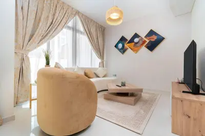 a living room with a couch and a tv at Calm Aesthetic 3 Bedroom Villa in Dubai