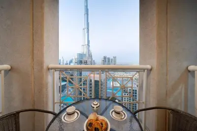 a table with a view of a city from a window at Bellavista - Dazzling High Floor - 2BR - 29 BOULEVARD - Burj Khalifa & Fountain View in Dubai