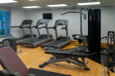 a gym with several tread machines in a room at Bellavista - Dazzling High Floor - 2BR - 29 BOULEVARD - Burj Khalifa & Fountain View in Dubai
