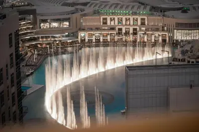 a large pool of water in a large building at Bellavista - Dazzling High Floor - 2BR - 29 BOULEVARD - Burj Khalifa & Fountain View in Dubai