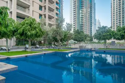 a swimming pool in a city with tall buildings at Bellavista - Splendid - 2BR plus Maid - 29 Boulevard - Burj Khalifa & Fountain in Dubai