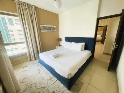 a bedroom with a bed and a large window at Bellavista - Splendid - 2BR plus Maid - 29 Boulevard - Burj Khalifa & Fountain in Dubai