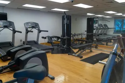 a gym with several tread machines in a room at Bellavista - High Floor - 1BR - 29 Boulevard - Burj Khalifa & Fountain View in Dubai