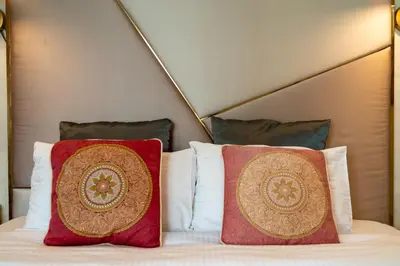 two pillows sitting on top of a bed at Bellavista - Graceful - 2 BR - 29 Boulevard - Fountain Views in Dubai