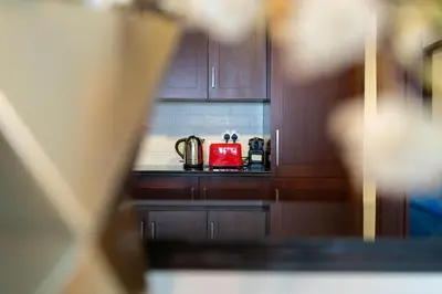 a kitchen with a red tea kettle on a counter at Bellavista - Graceful - 2 BR - 29 Boulevard - Fountain Views in Dubai